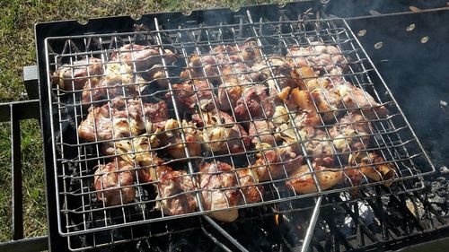 High angle view of meat on barbecue grill