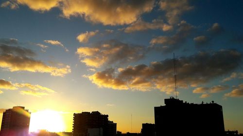 Low angle view of silhouette buildings against sky during sunset