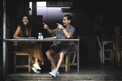 Young couple sitting at street restaurant in thailand 