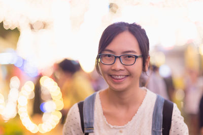 Portrait of smiling young woman standing outdoors