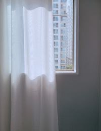 Close-up of curtain against window at home