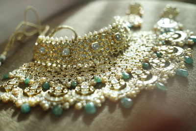 High angle view of necklace on wooden table