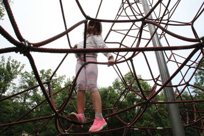 Low angle view of girl playing in playground