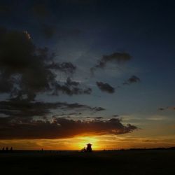 Silhouette of landscape against dramatic sky