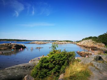 Scenic view of lake against clear blue sky