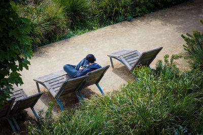 High angle view of man sitting on deck chair