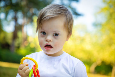 Portrait of disabled boy holding toy