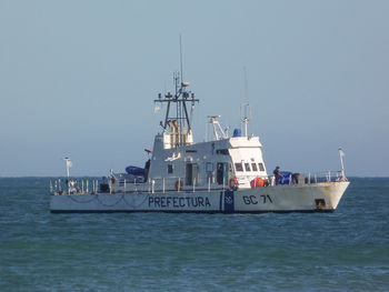 Ship sailing in sea against clear sky