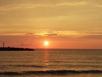 Scenic view of sea against romantic sky at sunset