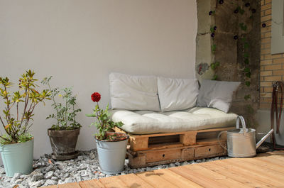 Pallet couch on terrace. outdoor relax place with cozy pillow on wooden couch.