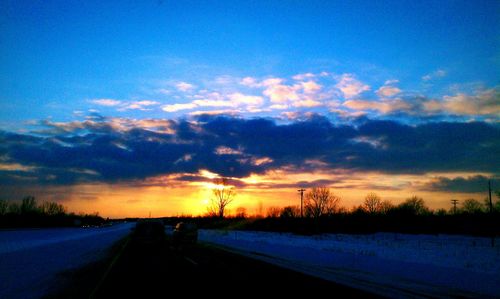 Snow covered landscape at sunset