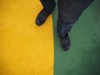 Low section of man standing on floor