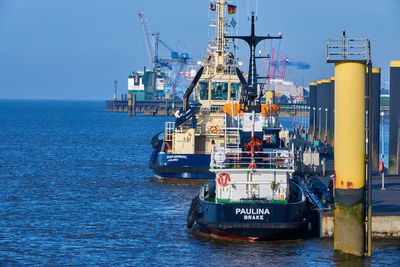 Commercial dock by sea against sky