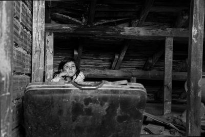 Portrait of girl sitting in abandoned building