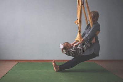 Full length of woman exercising in gym