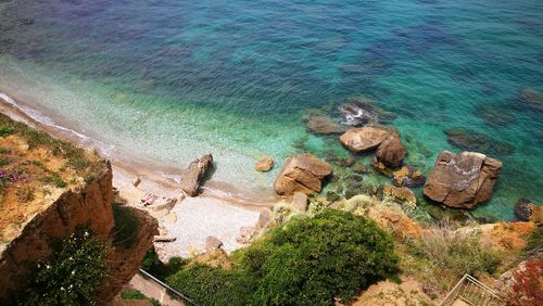 High angle view of rocks in sea