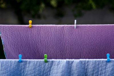 Close-up of blankets hanging on clothesline