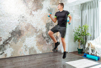 Full length of woman exercising in gym