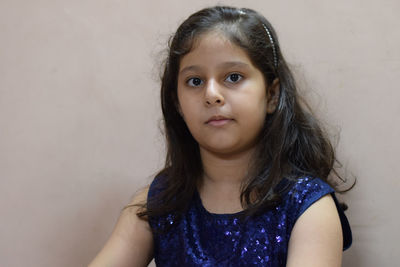 Portrait of cute girl against wall