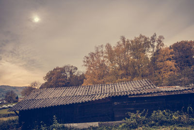 House by trees against sky