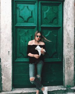 Young woman with closed door