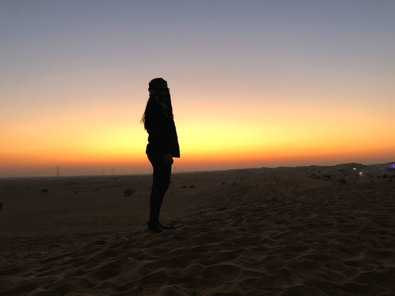 sunset, sky, land, sand, beach, one person, orange color, beauty in nature, scenics - nature, full length, real people, lifestyles, tranquility, leisure activity, tranquil scene, standing, copy space, nature, women, outdoors, arid climate