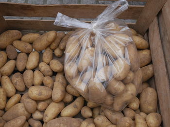 High angle view of potatoes in plastic bag for sale at market