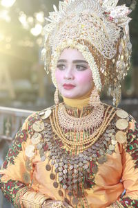 Woman wearing traditional clothing while standing against railing