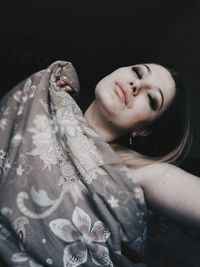 Portrait of beautiful young woman holding textile