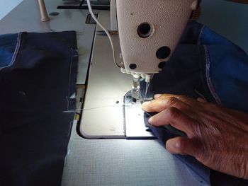 Midsection of man working on machine