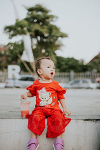 Cute girl drinking juice at park