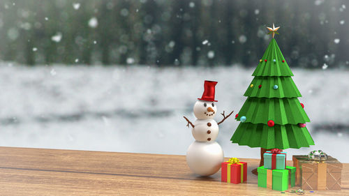 Close-up of toy on snow on table during winter