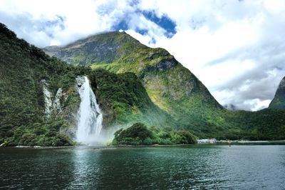 View of waterfall against rocky mountains