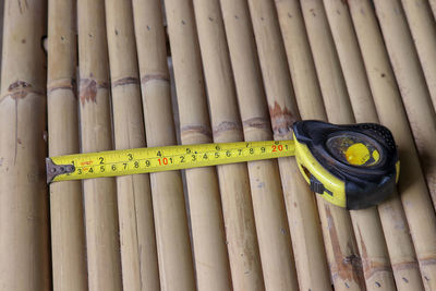 High angle view of tape measure on bamboos