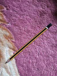 High angle view of pink pencils on wood