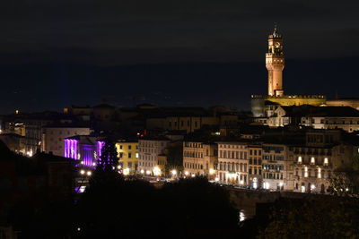 High angle view of buildings lit up at night