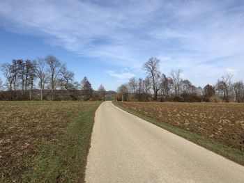 Empty road along countryside landscape