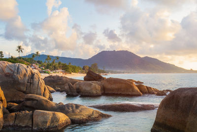 Rocks on beach against sky