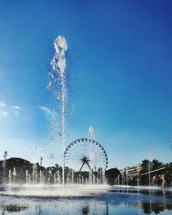 Ferris wheel against clear blue sky