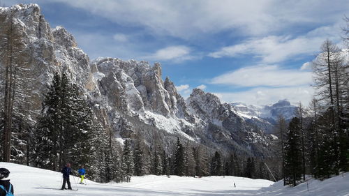 People skiing on snow covered land