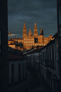 Buildings against cloudy sky in city