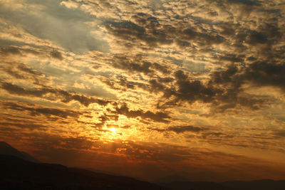 Low angle view of dramatic sky during sunset