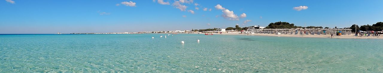 Scenic view of beach against blue sky