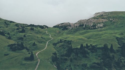 Scenic view of green landscape against sky