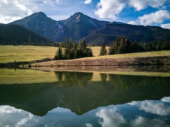 Scenic view of lake and mountains against sky