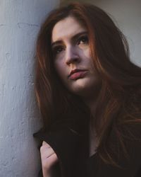 Portrait of beautiful woman against wall