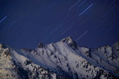 Scenic view of snowcapped mountains against sky during rainy season