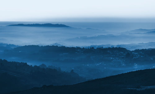 Scenic view of silhouette mountains against sky