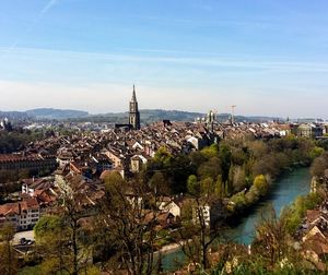 High angle view of townscape by river against sky