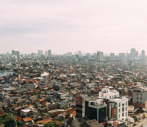 High angle view of buildings in city against sky